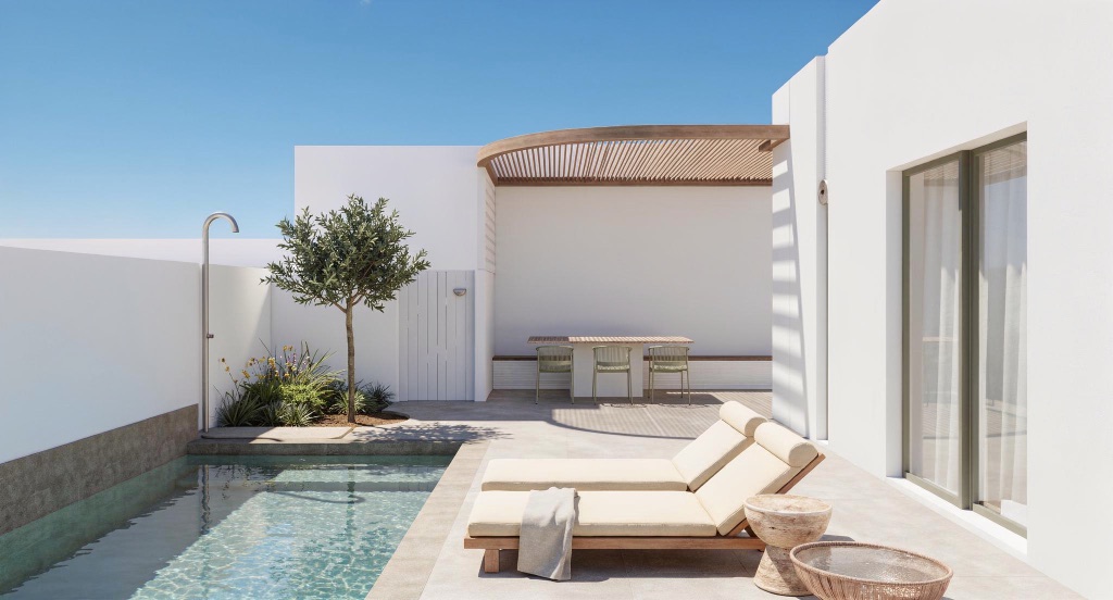 Nocturne's private courtyard with a curved iroko pergola, a plunge pool, an outdoor shower and a dining table.