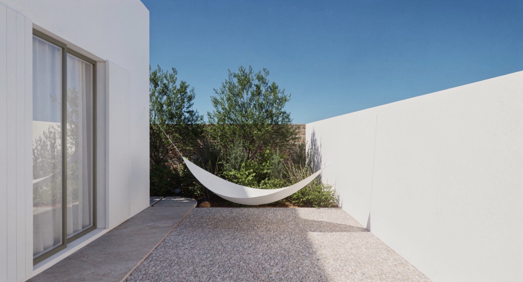 A white hammock slung across Nocturne's gravel courtyard against green shrubs.