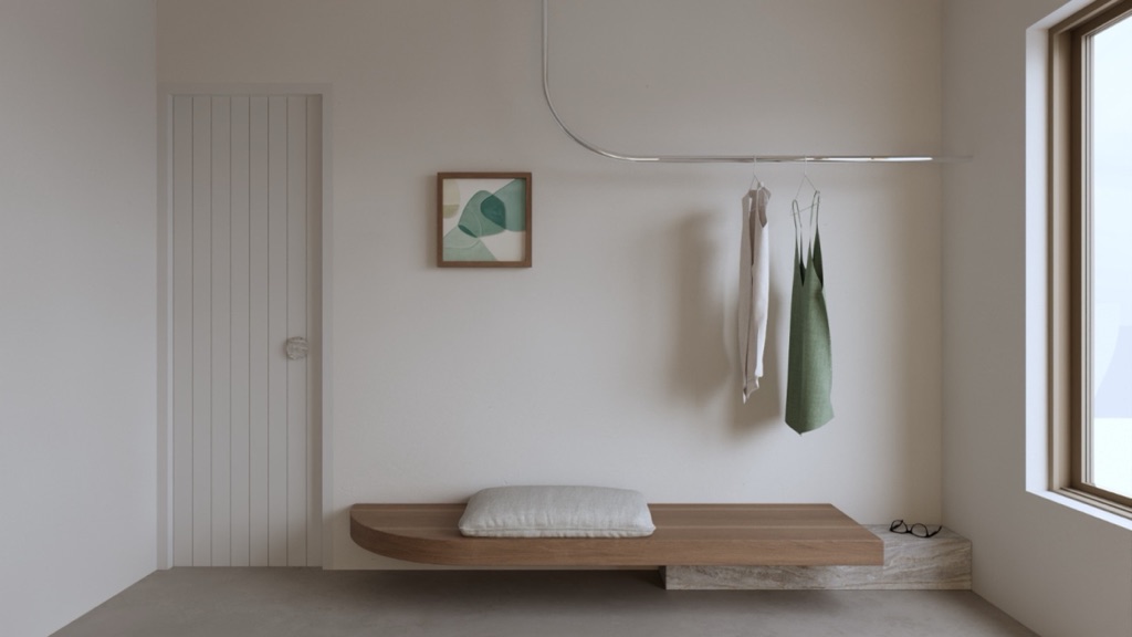 Pale wardrobe nook with hanging linen dresses and a wooden bench.